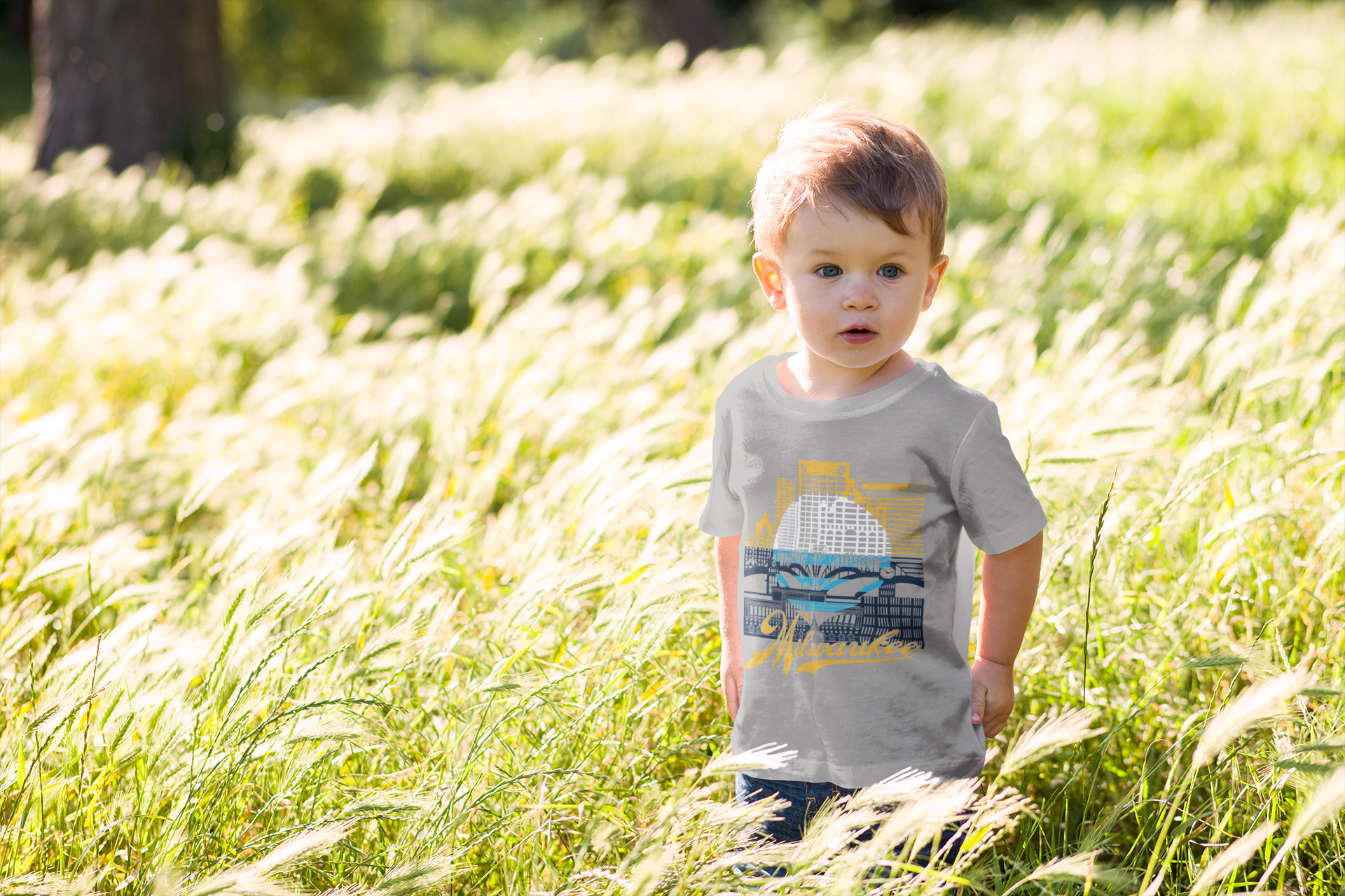 Little boy in field with Milwaukee tshirt